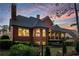 Brick home with an outdoor seating area overlooking manicured landscaping at 145 Cuthbert Ln, Acworth, GA 30101