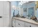 Comfortable bathroom with a granite countertop and white cabinets, as well as a large mirror at 145 Cuthbert Ln, Acworth, GA 30101