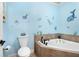 Cute bathroom featuring blue walls decorated with ocean animals and a tile-surround tub at 145 Cuthbert Ln, Acworth, GA 30101