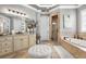 Spa-like bathroom with double vanities, soaking tub, walk-in shower, and elegant fixtures for relaxation at 145 Cuthbert Ln, Acworth, GA 30101