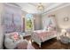 Charming bedroom features a decorative chandelier, and a large window at 145 Cuthbert Ln, Acworth, GA 30101