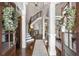 Elegant foyer with hardwood floors, staircase, and decorative wreaths on glass doors at 145 Cuthbert Ln, Acworth, GA 30101