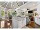 Open-concept kitchen with a stone fireplace in the adjoining Gathering room and a farmhouse sink at 145 Cuthbert Ln, Acworth, GA 30101