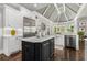 Spacious kitchen with stainless appliances, a black island, marble countertops and a farmhouse sink at 145 Cuthbert Ln, Acworth, GA 30101