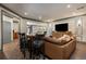 Open-concept living area with a large TV, hardwood floors, and bar seating for entertaining guests at 145 Cuthbert Ln, Acworth, GA 30101