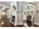 Inviting living room with fireplace, staircase, and ample natural light streaming through large windows at 145 Cuthbert Ln, Acworth, GA 30101