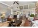 Open concept living room showcasing hardwood floors, stylish decor, and seamless flow into the kitchen area at 145 Cuthbert Ln, Acworth, GA 30101