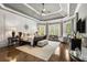 Luxurious main bedroom with tray ceiling, hardwood floors, large windows, and decorative furnishings at 145 Cuthbert Ln, Acworth, GA 30101