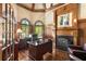 Elegant office with custom wood, built-ins, and cozy leather seating at 145 Cuthbert Ln, Acworth, GA 30101