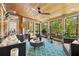 Relaxing screened porch with wood ceiling, outdoor seating, and views of surrounding greenery at 145 Cuthbert Ln, Acworth, GA 30101