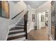 Inviting staircase featuring hardwood floors and decorative iron railings, offering an elegant transition at 145 Cuthbert Ln, Acworth, GA 30101