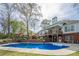 Inviting backyard with large swimming pool, wooden deck, and landscaped garden area at 2121 Rock Court, Loganville, GA 30052