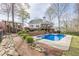 Swimming pool with diving board, patio, and pergola in well-landscaped backyard at 2121 Rock Court, Loganville, GA 30052