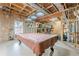 Basement pool-table space with exposed ceiling and wood framing, ready for finishing at 2121 Rock Court, Loganville, GA 30052