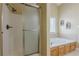 This bathroom features a shower, a tub with tile backsplash, and natural lighting at 2121 Rock Court, Loganville, GA 30052