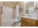 Well-lit bathroom featuring a shower-tub combo, toilet, and vanity with sink at 2121 Rock Court, Loganville, GA 30052