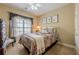 Cozy bedroom with a ceiling fan, window with curtains, and neutral decor at 2121 Rock Court, Loganville, GA 30052