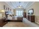 Elegant bedroom featuring a tray ceiling, a large window, neutral carpeting, and wooden furniture at 2121 Rock Court, Loganville, GA 30052