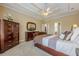 Spacious bedroom with neutral carpeting, featuring a tray ceiling and classic wooden furniture at 2121 Rock Court, Loganville, GA 30052