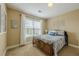 Comfortable bedroom with a window, curtains, bed and bright natural light at 2121 Rock Court, Loganville, GA 30052