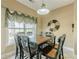 Charming dining area with a backyard view, adorned with decorative curtains and overhead lighting at 2121 Rock Court, Loganville, GA 30052