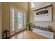 Welcoming foyer featuring decorative glass front door, elegant bench, and stylish decor at 2121 Rock Court, Loganville, GA 30052