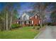 Charming two-story red brick home featuring manicured lawn and attractive landscaping at 2121 Rock Court, Loganville, GA 30052