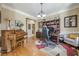 Another view of the bright home office featuring hardwood floors, piano and built in desk at 2121 Rock Court, Loganville, GA 30052