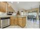 Kitchen sink area with granite countertops, stainless appliances, and view of the dining and living areas at 2121 Rock Court, Loganville, GA 30052