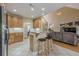Open-concept kitchen with stone countertops and breakfast bar, adjacent to the living room and staircase at 2121 Rock Court, Loganville, GA 30052