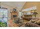 Cozy living room featuring a stone fireplace, hardwood floors, and comfortable seating at 2121 Rock Court, Loganville, GA 30052