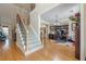 Spacious living room showcasing hardwood floors, staircase and comfortable seating at 2121 Rock Court, Loganville, GA 30052