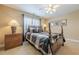 Bedroom with neutral walls, carpet flooring, a ceiling fan, and a sunny window at 2121 Rock Court, Loganville, GA 30052