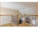 Staircase with carpeted steps, wood railing, and view of the living room below at 2121 Rock Court, Loganville, GA 30052