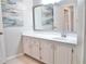 Bright bathroom with a large mirror, white cabinets, and neutral colored walls at 970 Sidney Marcus Ne Blvd # 2203, Atlanta, GA 30324