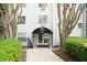 Welcoming condo building entrance with professional landscaping and covered entry at 970 Sidney Marcus Ne Blvd # 2203, Atlanta, GA 30324