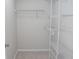 A walk-in closet featuring white wire shelving and neutral carpet at 970 Sidney Marcus Ne Blvd # 2203, Atlanta, GA 30324