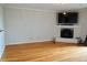 Inviting living room featuring hardwood floors and cozy fireplace with mounted TV at 970 Sidney Marcus Ne Blvd # 2203, Atlanta, GA 30324