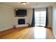 Cozy living room with hardwood floors, fireplace and direct access to a balcony at 970 Sidney Marcus Ne Blvd # 2203, Atlanta, GA 30324