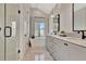 Modern bathroom featuring double vanity, soaking tub, and glass shower at 165 2Nd St, Fayetteville, GA 30214