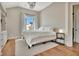 Bright bedroom with hardwood floors, white walls, and a large window at 165 2Nd St, Fayetteville, GA 30214