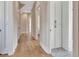 Hallway with hardwood floors, neutral paint, and storage cupboard at 165 2Nd St, Fayetteville, GA 30214