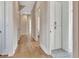 Inviting hallway with hardwood floors, white trim and doors, and a storage closet at 165 2Nd St, Fayetteville, GA 30214