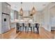 Modern kitchen boasts stainless steel appliances, ample counter space, stylish pendant lights, and hardwood floors at 165 2Nd St, Fayetteville, GA 30214