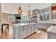 Open-concept kitchen with island seating, stainless steel appliances, hardwood floors, and plenty of natural light at 165 2Nd St, Fayetteville, GA 30214