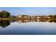 Stunning lake view showing a row of beautiful homes mirrored in the water at 165 2Nd St, Fayetteville, GA 30214