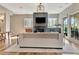 Open-concept living room featuring hardwood floors, modern fireplace, and glass doors leading to the patio at 165 2Nd St, Fayetteville, GA 30214