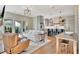 Open living area flows into a stylish kitchen with stainless steel appliances, hardwood floors, and modern lighting at 165 2Nd St, Fayetteville, GA 30214