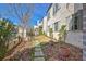 Well-maintained side yard with stone pathway and landscaped garden beds at 165 2Nd St, Fayetteville, GA 30214
