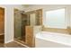 Bathroom featuring separate shower and tub with tile surround and modern fixtures at 245 Astoria Way, Mcdonough, GA 30253